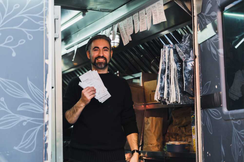 Tony holding a receipt